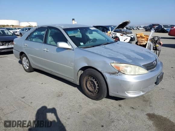 2002 Toyota Camry LE with VIN 4T1BE32K42U552229, listed as a Copart auction lot 84379825 with 258,234 mi miles and Salvage title. Bid and sale history available at DreamBid. Image 4.