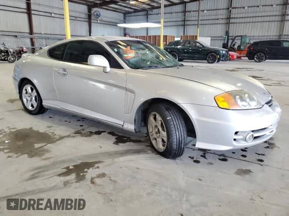 2004 Hyundai Tiburon GS z VIN KMHHM65D74U144595, wystawiony jako Copart lot #84241315 z przebiegiem 184 108 mil mil oraz Szkoda całkowita • Salvage title. Historia ofert i sprzedaży dostępna na DreamBid. Obrazek 4.
