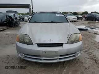 2003 Hyundai Tiburon GT z VIN KMHHN65F23U084299, wystawiony jako Copart lot #75105394 z przebiegiem 90 598 mil mil oraz Czysty tytuł • Clean title. Historia ofert i sprzedaży dostępna na DreamBid. Obrazek 5.