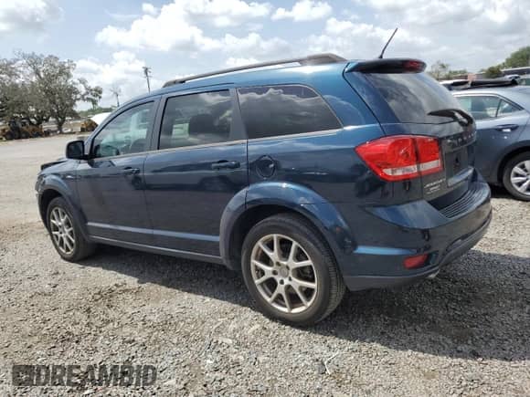 2014 Dodge Journey SXT with VIN 3C4PDCBG2ET217784, listed as a Copart auction lot 60124435 with 104,179 mi miles and Salvage title. Bid and sale history available at DreamBid. Image 2.