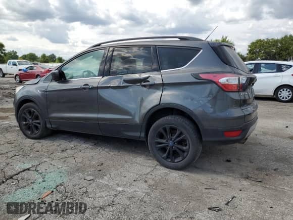 2017 Ford Escape SE с VIN 1FMCU9GD6HUA56720, выставлен на аукционе Copart как лот 70484625 с пробегом 128 058 миль миль и Чистый • Clean title. История ставок и продаж доступна на DreamBid. Изображение 2.