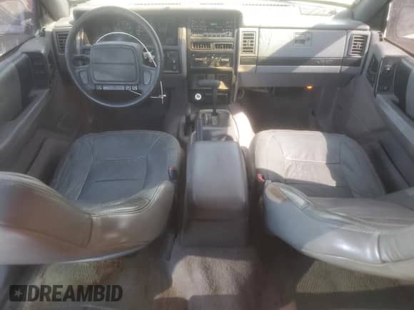 1995 Jeep Grand Cherokee Laredo with VIN 1J4GZ58Y6SC712472, listed as a Copart auction lot 80547635 with 214,089 mi miles and Salvage title. Bid and sale history available at DreamBid. Image 8.