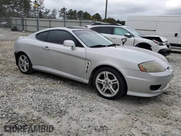 2005 Hyundai Tiburon GS with VIN KMHHM65D05U184230, listed as a Copart auction lot 80068374 with 135,076 mi miles and Salvage title. Bid and sale history available at DreamBid. Image 4.