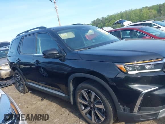 2023 Honda Pilot Touring с VIN 5FNYG2H77PB002996, выставлен на аукционе IAAI как лот 42070607 с пробегом 31 875 миль миль и . История ставок и продаж доступна на DreamBid. Изображение 14.