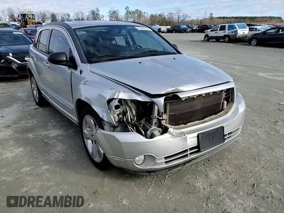 2011 Dodge Caliber Rush with VIN 1B3CB8HB0BD254591, listed as a Copart auction lot 85888784 with 174,776 mi miles and Salvage title. Bid and sale history available at DreamBid. Image 11.