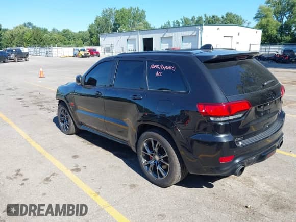 2016 Jeep Grand Cherokee SRT with VIN 1C4RJFDJ8GC306401, listed as a IAAI auction lot 42782259 with 116,318 mi miles and . Bid and sale history available at DreamBid. Image 3.