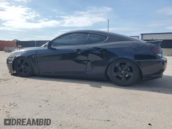 2006 Hyundai Tiburon GS with VIN KMHHM65D06U191468, listed as a Copart auction lot 70183555 with 195,594 mi miles and Salvage title. Bid and sale history available at DreamBid. Image 2.