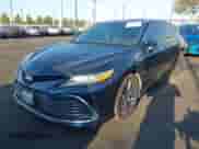 2021 Toyota Camry Hybrid XLE with VIN 4T1F31AK9MU547267, listed as a IAAI auction lot 42732726 with 106,937 mi miles and . Bid and sale history available at DreamBid. Image 2.