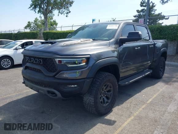 2022 Ram 1500 TRX with VIN 1C6SRFU91NN392885, listed as a IAAI auction lot 42482710 with 13,090 mi miles and . Bid and sale history available at DreamBid. Image 6.