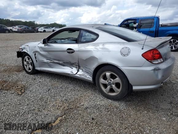 2005 Hyundai Tiburon GS z VIN KMHHM65D35U182780, wystawiony jako Copart lot #58958295 z przebiegiem 186 652 mil mil oraz Czysty tytuł • Clean title. Historia ofert i sprzedaży dostępna na DreamBid. Obrazek 2.