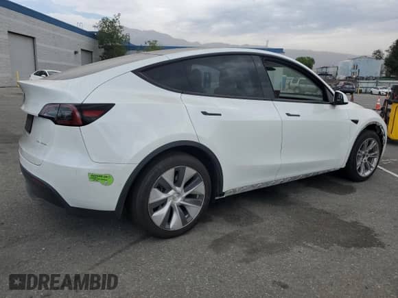 2023 Tesla Model Y Long Range with VIN 7SAYGAEE2PF590760, listed as a Copart auction lot 69752835 with 57,026 mi miles and Salvage title. Bid and sale history available at DreamBid. Image 3.