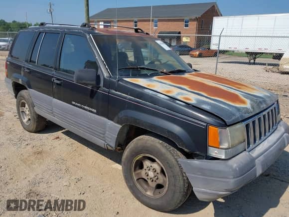 1996 Jeep Grand Cherokee Laredo z VIN 1J4GZ58SXTC280868, wystawiony jako IAAI lot #42653608 z przebiegiem 188 867 mil mil oraz . Historia ofert i sprzedaży dostępna na DreamBid. Obrazek 1.