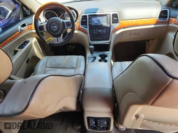 2012 Jeep Grand Cherokee Overland with VIN 1C4RJFCT9CC346497, listed as a Copart auction lot 63004635 with 142,623 mi miles and Salvage title. Bid and sale history available at DreamBid. Image 8.