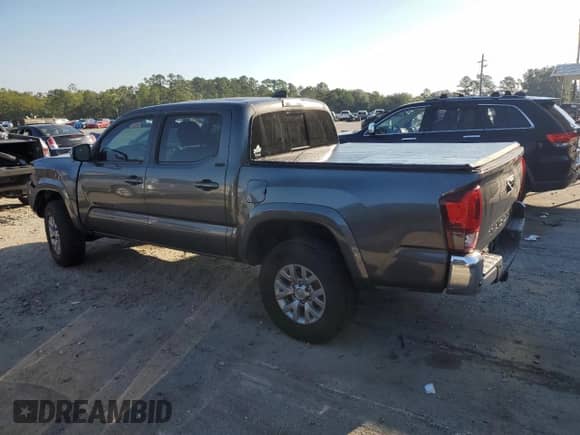 2018 Toyota Tacoma SR5 with VIN 3TMAZ5CNXJM073034, listed as a Copart auction lot 80509895 with 121,163 mi miles and Salvage title. Bid and sale history available at DreamBid. Image 2.