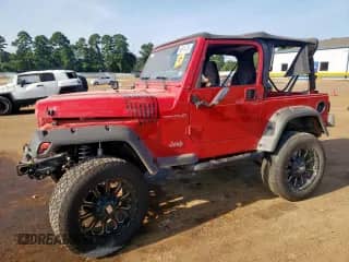 2000 Jeep Wrangler SE with VIN 1J4FA29P6YP703375, listed as a Copart auction lot 66914735 with 174,624 mi miles and Salvage title. Bid and sale history available at DreamBid. Image 1.