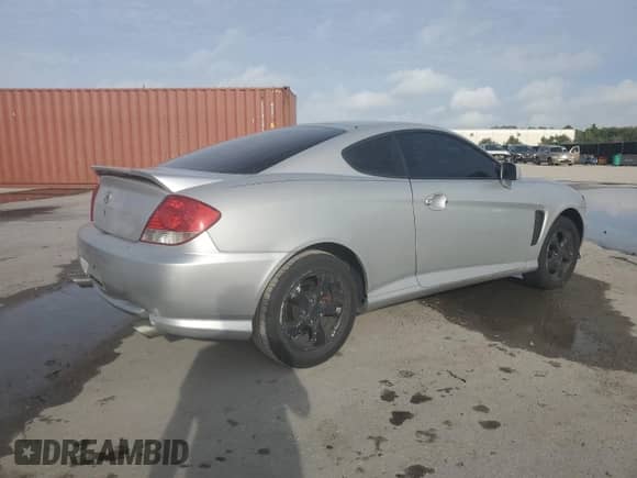 2006 Hyundai Tiburon GS с VIN KMHHM65D76U222358, выставлен на аукционе Copart как лот 64834055 с пробегом 129 477 миль миль и Списание • Salvage title. История ставок и продаж доступна на DreamBid. Изображение 3.