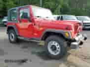 2000 Jeep Wrangler SE with VIN 1J4FA29P8YP711686, listed as a Copart auction lot 68999455 with 100,108 mi miles and Salvage title. Bid and sale history available at DreamBid. Image 4.