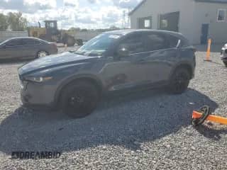2023 Mazda CX-5 S Carbon Edition z VIN JM3KFBCM7P0169757, wystawiony jako Copart lot #70624645 z przebiegiem 31 275 mil mil oraz Szkoda całkowita • Salvage title. Historia ofert i sprzedaży dostępna na DreamBid. Obrazek 1.