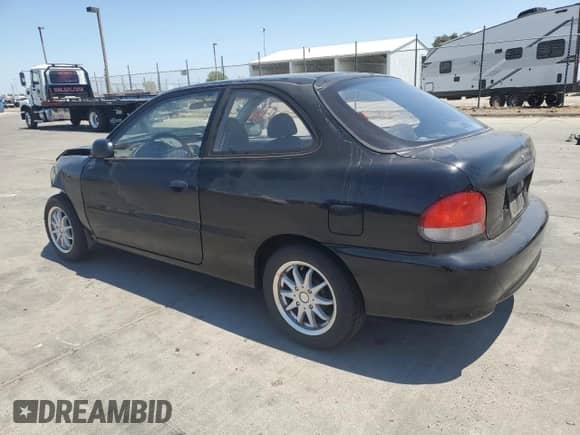 1999 Hyundai Accent L with VIN KMHVD14N4XU428030, listed as a Copart auction lot 65271195 with 151,064 mi miles and Salvage title. Bid and sale history available at DreamBid. Image 2.