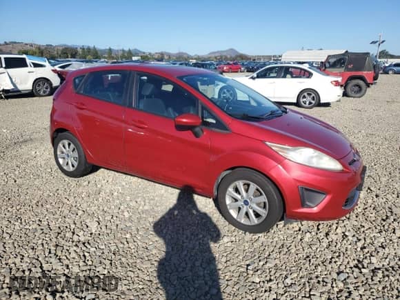 2012 Ford Fiesta SE with VIN 3FADP4EJ7CM173494, listed as a Copart auction lot 82229335 with 83,628 mi miles and Salvage title. Bid and sale history available at DreamBid. Image 4.