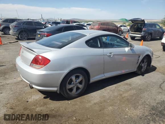 2005 Hyundai Tiburon GS с VIN KMHHM65D45U175370, выставлен на аукционе Copart как лот 64657525 с пробегом 215 287 миль миль и Списание • Salvage title. История ставок и продаж доступна на DreamBid. Изображение 3.
