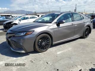 2021 Toyota Camry Hybrid XSE with VIN 4T1K31AK9MU565539, listed as a Copart auction lot 86149585 with 115,658 mi miles and Salvage title. Bid and sale history available at DreamBid. Image 1.