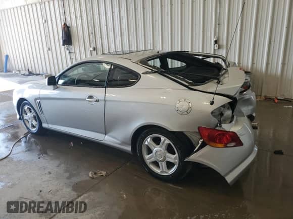 2003 Hyundai Tiburon GT с VIN KMHHN65F53U019155, выставлен на аукционе Copart как лот 67763185 с пробегом 66 114 миль миль и На запчасти • Non repairable. История ставок и продаж доступна на DreamBid. Изображение 2.