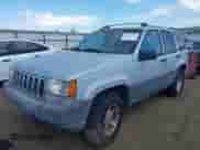 1996 Jeep Grand Cherokee Laredo z VIN 1J4GZ58S9TC245352, wystawiony jako IAAI lot #42860561 z przebiegiem Nie podano mil oraz . Historia ofert i sprzedaży dostępna na DreamBid. Obrazek 2.