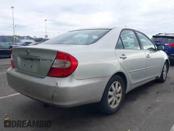 2002 Toyota Camry LE with VIN 4T1BE30K22U601060, listed as a IAAI auction lot 43443949 with 241,972 mi miles and . Bid and sale history available at DreamBid. Image 4.