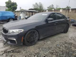 2018 BMW 5 Series M550i xDrive with VIN WBAJB9C54JB035699, listed as a Copart auction lot 71395105 with 94,373 mi miles and Salvage title. Bid and sale history available at DreamBid. Image 1.