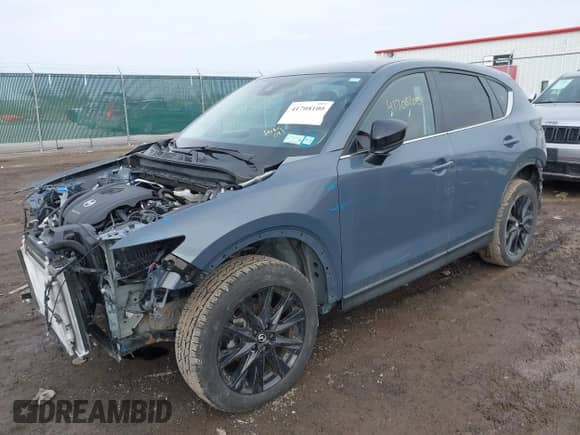 2022 Mazda CX-5 S Carbon Edition z VIN JM3KFBCM2N0529241, wystawiony jako IAAI lot #41708100 z przebiegiem 24 139 mil mil oraz . Historia ofert i sprzedaży dostępna na DreamBid. Obrazek 2.