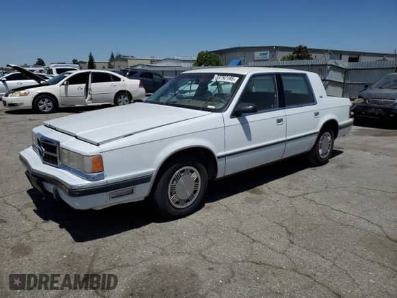 1989 Dodge Dynasty with VIN 1B3BC463XKD594439, listed as a Copart auction lot 65792195 with 61,970 mi miles and Clean title. Bid and sale history available at DreamBid. Image 1.