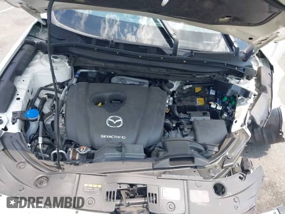 2023 Mazda CX-5 S Carbon Edition z VIN JM3KFBCMXP0211676, wystawiony jako IAAI lot #42642351 z przebiegiem 13 447 mil mil oraz . Historia ofert i sprzedaży dostępna na DreamBid. Obrazek 10.