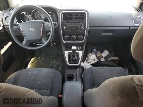 2011 Dodge Caliber z VIN 1B3CB1HA0BD156210, wystawiony jako Copart lot #65667744 z przebiegiem 156 798 mil mil oraz Szkoda całkowita • Salvage title. Historia ofert i sprzedaży dostępna na DreamBid. Obrazek 8.