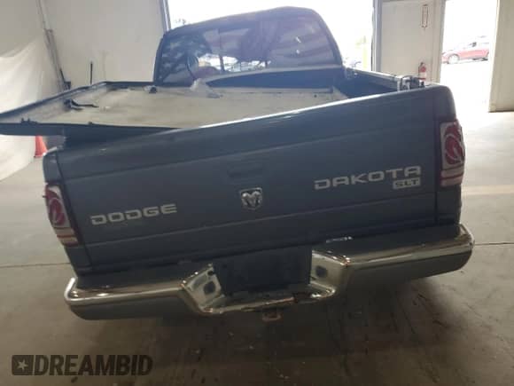 2003 Dodge Dakota SLT z VIN 1D7HG48N63S296100, wystawiony jako Copart lot #68014165 z przebiegiem Nie podano mil oraz Szkoda całkowita • Salvage title. Historia ofert i sprzedaży dostępna na DreamBid. Obrazek 6.
