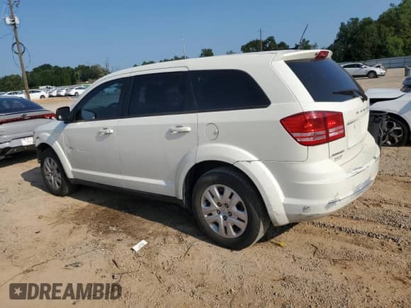 2014 Dodge Journey SE with VIN 3C4PDCAB5ET310739, listed as a Copart auction lot 69391595 with 128,134 mi miles and Salvage title. Bid and sale history available at DreamBid. Image 2.
