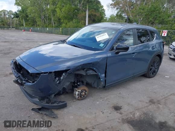 2022 Mazda CX-5 S Carbon Edition z VIN JM3KFBCM3N0551653, wystawiony jako IAAI lot #41495011 z przebiegiem 49 842 mil mil oraz . Historia ofert i sprzedaży dostępna na DreamBid. Obrazek 2.