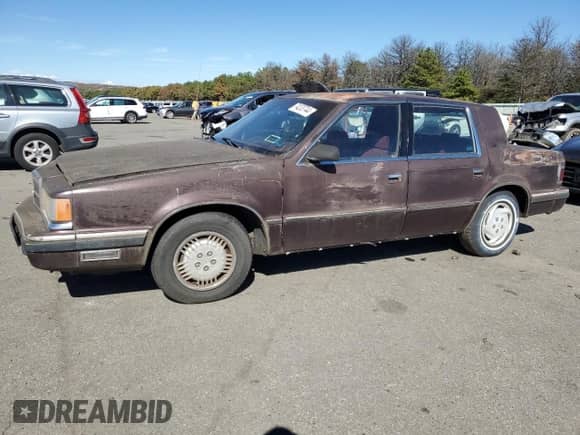 1989 Dodge Dynasty with VIN 1B3BC4637KD532206, listed as a Copart auction lot 74233744 with 85,245 mi miles and Clean title. Bid and sale history available at DreamBid. Image 1.