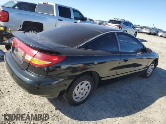1997 Saturn SC with VIN 1G8ZF1286VZ266912, listed as a Copart auction lot 46953875 with 149,017 mi miles and Salvage title. Bid and sale history available at DreamBid. Image 3.