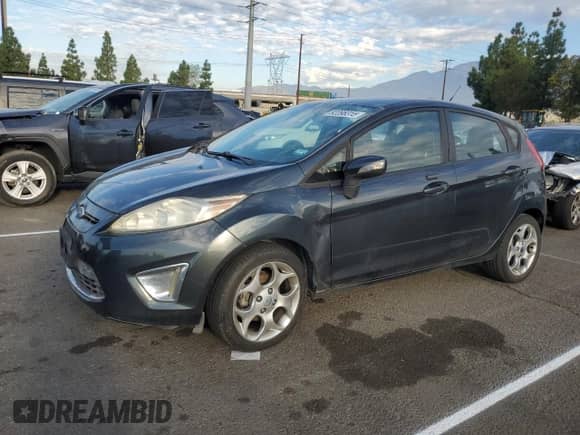 2011 Ford Fiesta SES with VIN 3FADP4FJ0BM109049, listed as a Copart auction lot 82098315 with 147,557 mi miles and Salvage title. Bid and sale history available at DreamBid. Image 1.
