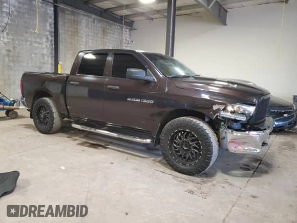2011 Ram 1500 ST with VIN 1D7RV1CP1BS638908, listed as a Copart auction lot 77098224 with 128,010 mi miles and Salvage title. Bid and sale history available at DreamBid. Image 4.