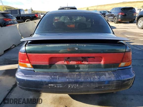 1999 Saturn SL with VIN 1G8ZJ5272XZ141986, listed as a Copart auction lot 71496674 with Not provided miles and Salvage title. Bid and sale history available at DreamBid. Image 6.