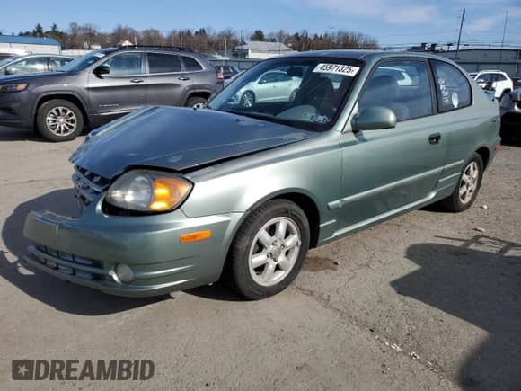 2003 Hyundai Accent GL z VIN KMHCG35CX3U242820, wystawiony jako Copart lot #45971325 z przebiegiem 132 192 mil mil oraz Szkoda całkowita • Salvage title. Historia ofert i sprzedaży dostępna na DreamBid. Obrazek 1.