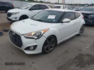 2014 Hyundai Veloster Turbo z VIN KMHTC6AE1EU182501, wystawiony jako IAAI lot #43333749 z przebiegiem 157 957 mil mil oraz . Historia ofert i sprzedaży dostępna na DreamBid. Obrazek 2.