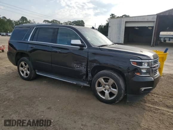 2015 Chevrolet Tahoe LTZ with VIN 1GNSCCKC9FR636937, listed as a Copart auction lot 81036145 with 101,034 mi miles and Salvage title. Bid and sale history available at DreamBid. Image 4.