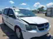2014 Dodge Grand Caravan SE with VIN 2C4RDGBG0ER450775, listed as a IAAI auction lot 42589472 with 11 mi miles and . Bid and sale history available at DreamBid. Image 1.