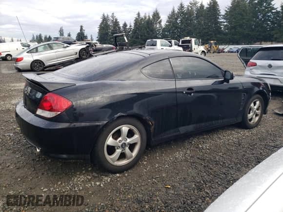 2006 Hyundai Tiburon GS with VIN KMHHM65DX6U225464, listed as a Copart auction lot 83561984 with 182,245 mi miles and Salvage title. Bid and sale history available at DreamBid. Image 3.