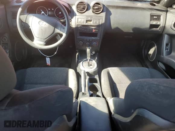 2003 Hyundai Tiburon с VIN KMHHM65D53U102506, выставлен на аукционе Copart как лот 82784104 с пробегом 148 359 миль миль и На запчасти • Non repairable. История ставок и продаж доступна на DreamBid. Изображение 8.