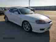 2006 Hyundai Tiburon GT z VIN KMHHN65F46U191990, wystawiony jako Copart lot #61887894 z przebiegiem 252 384 mil mil oraz Szkoda całkowita • Salvage title. Historia ofert i sprzedaży dostępna na DreamBid. Obrazek 4.