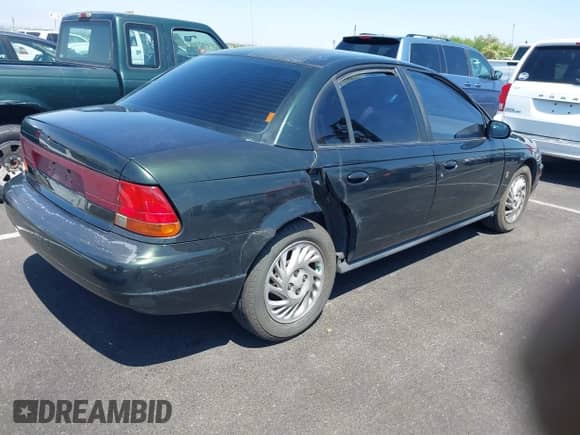1999 Saturn SL z VIN 1G8ZK5274XZ304652, wystawiony jako IAAI lot #42618620 z przebiegiem 98 131 mil mil oraz . Historia ofert i sprzedaży dostępna na DreamBid. Obrazek 4.